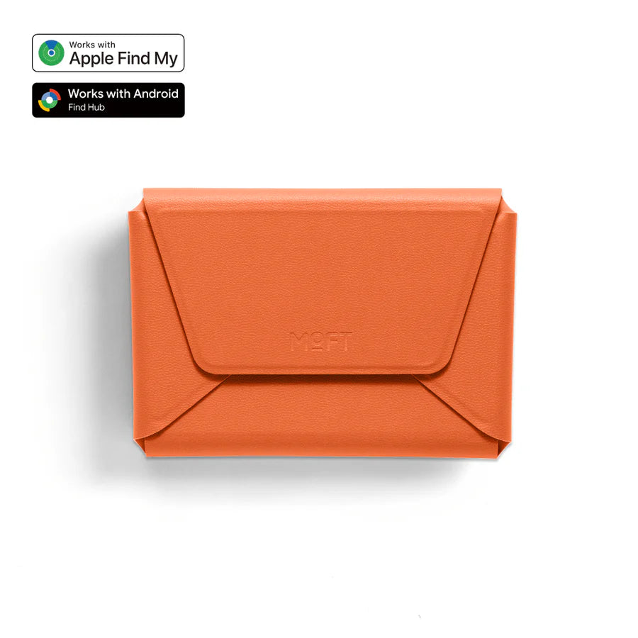 An orange envelope-style wallet or card holder with a flap closure and debossed 'MOFT' logo, shown on a white background with Apple Find My and Android Find Hub compatibility badges in the top-left corner.
